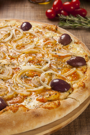 Traditional italian pizza with ingredients on wooden.の写真素材