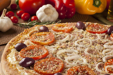 Traditional italian pizza with ingredients on wooden.の写真素材