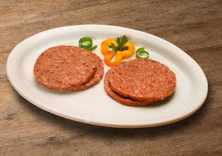 Raw meat selection on wooden cutting board.の写真素材