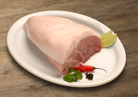 Pork tenderloin with herbs on wooden backgroundの写真素材
