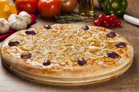 Traditional italian pizza with ingredients on wooden.の写真素材