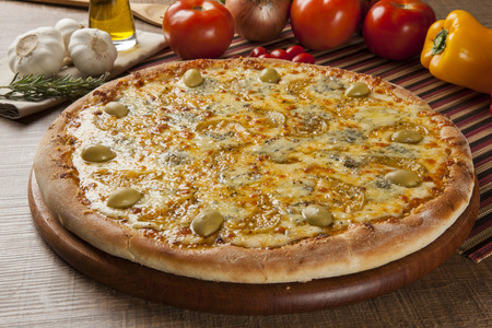 Traditional italian pizza with ingredients on wooden.の写真素材
