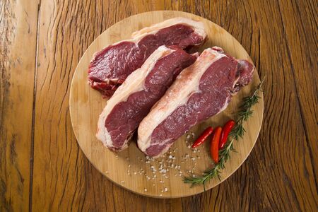 raw meat : fresh beef fillet with garlic and green stuff on boardの写真素材