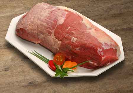 Raw meat selection on wooden cutting board.の写真素材