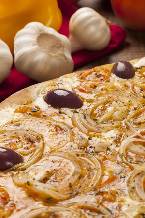 Traditional italian pizza with ingredients on wooden.の写真素材