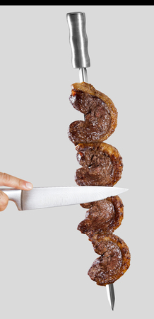 Spit roast sirloin in white background. Picanha barbecue.の写真素材