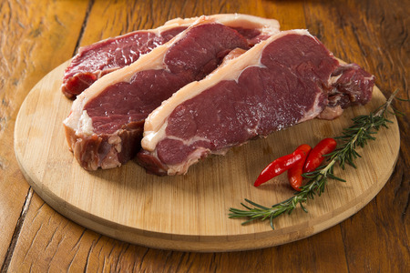 raw meat : fresh beef fillet with garlic and green stuff on boardの写真素材