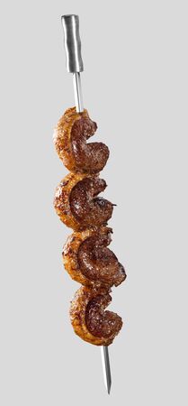 Spit roast sirloin in white background. Picanha barbecue.の写真素材