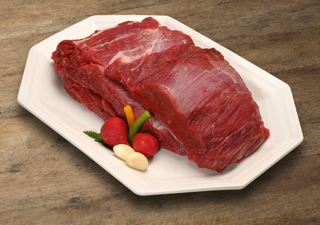 Raw meat selection on wooden cutting board.の写真素材
