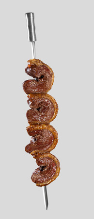 Spit roast sirloin in white background. Picanha barbecue.の写真素材