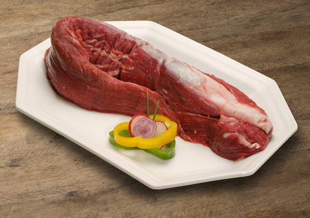 Raw meat selection on wooden cutting board.の写真素材