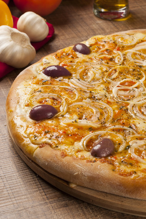 Traditional italian pizza with ingredients on wooden.の写真素材