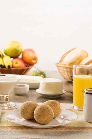 Brazilian cheese buns . Table cafe in the morning with cheese bread and fruits.の写真素材
