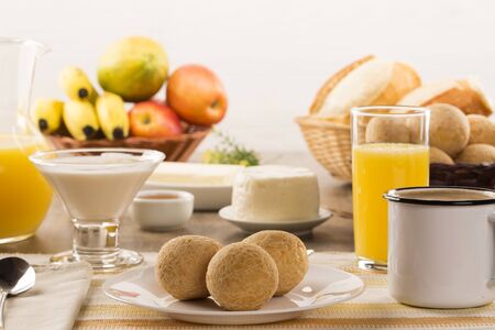 Brazilian cheese buns . Table cafe in the morning with cheese bread and fruits.の写真素材