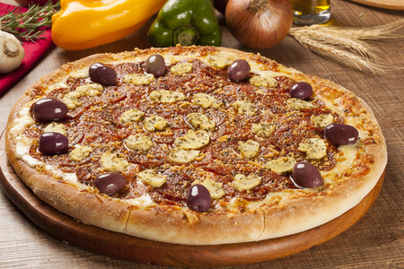 Traditional italian pizza with ingredients on wooden.の写真素材