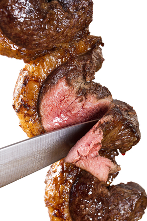 Spit roast sirloin in white background. Picanha barbecue.の写真素材
