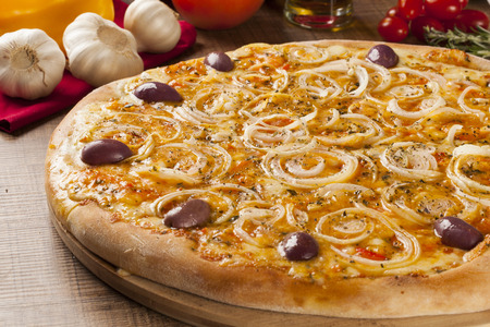 Traditional italian pizza with ingredients on wooden.の写真素材