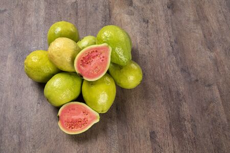 Some brazilian guavas over a wooden surface. Fresh fruits.の写真素材