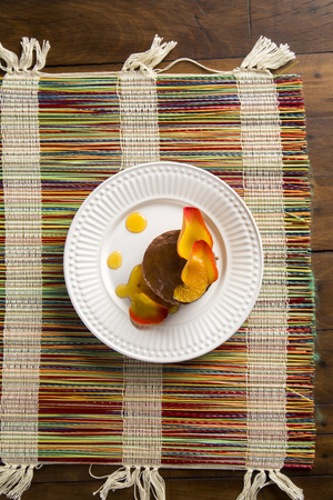 A dish of Chocolate Mousse with tangerine syrup over the table.の写真素材