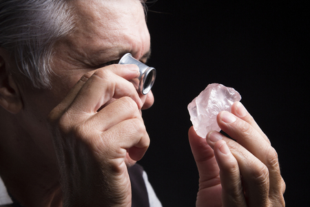 portrait of a jeweler during the evaluation of Gemstoneの写真素材