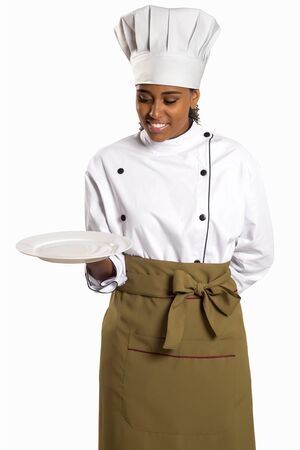 Woman cook or chef serving empty plate smiling happy isolated on white background.の写真素材