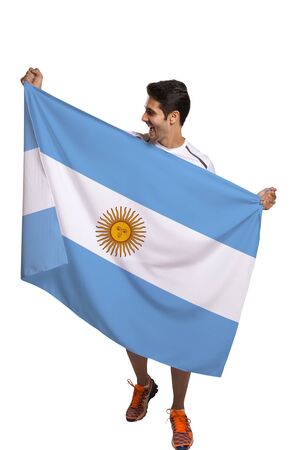 Fan holding the flag of Argentina celebrates on white backgroundの写真素材