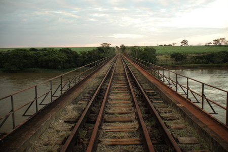 Old railroad track. Line train in background.の写真素材