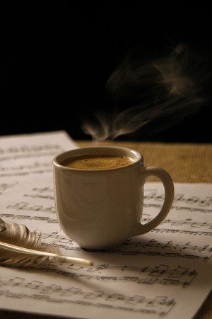 Cup of coffee on a music scoreの写真素材