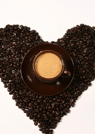 coffee beans forming a heart. Cup of coffee.の写真素材