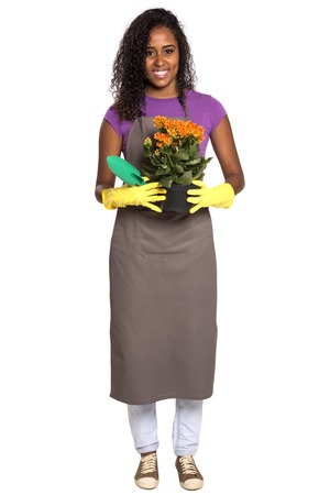 Beautiful african girl gardener with flower isolated on white backgroundの写真素材