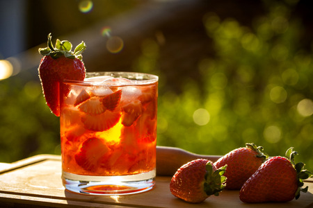 Fresh made Strawberry Caipirinha on green blurry backgroundの写真素材