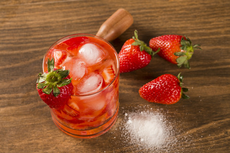 Fresh made Strawberry Caipirinha on wooden backgroundの写真素材