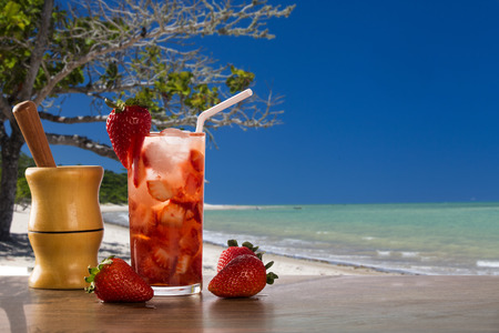 Fresh drink made Strawberry Caipirinha in the beach backgroundの写真素材