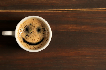 Good morning coffee smile cup on wooden backgroundの写真素材