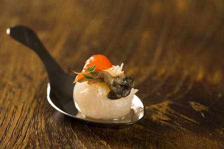 Lychee with sour cream, parmesan cheese, shimeji, red pepper and thyme in a spoon. Taste gastronomy finger foodの写真素材