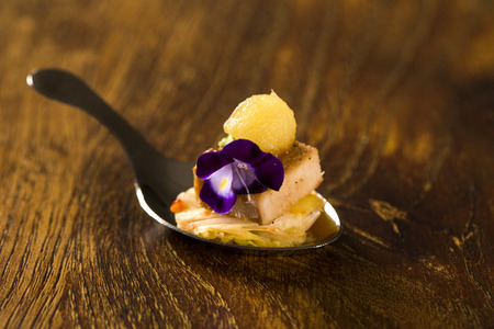 Swede with caramelized apple accompanied by Kimchi in a spoon. Taste gastronomy finger foodの写真素材