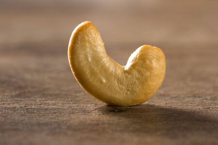cashew nuts close up on wood backgroundの写真素材
