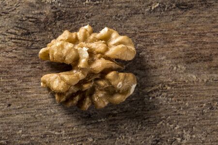 walnuts in wood bowl on wood table.