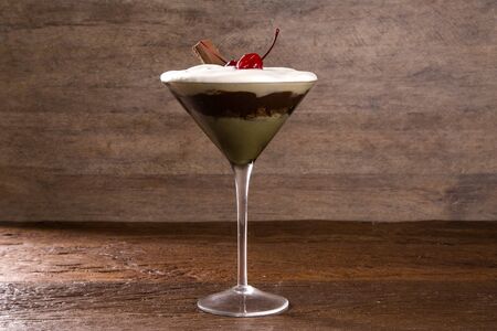 Delicious Italian dessert Pannacotta with chocolate and cherry