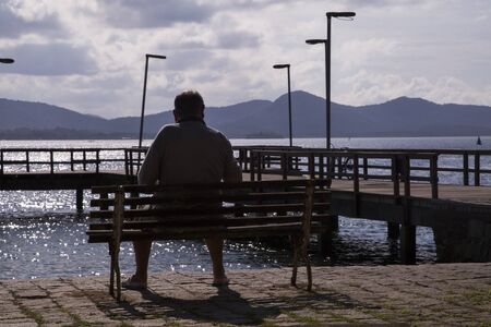 Man sitting looking at the sea. Sao francisco do sul. Santa Catarina. July 2017のeditorial素材