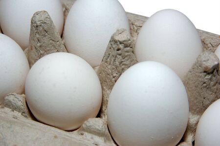 White eggs in a grey cardboard carton box