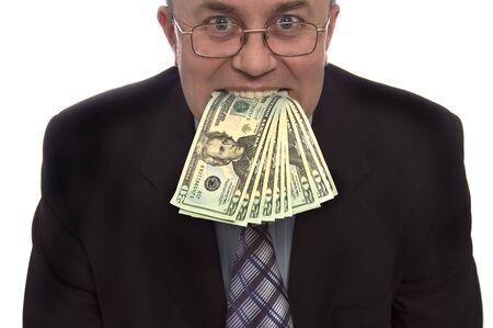 Businessman with money in mounthの写真素材