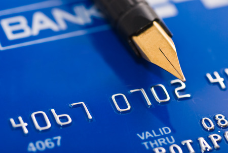 Close-up a pen over credit cardの写真素材