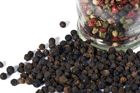 Close up of black peppercorns isolated over white backgroundの写真素材