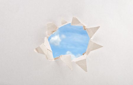 Large hole in the white paperの写真素材