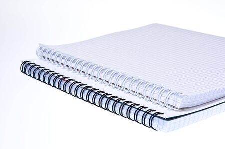empty spiral notebooks over white
