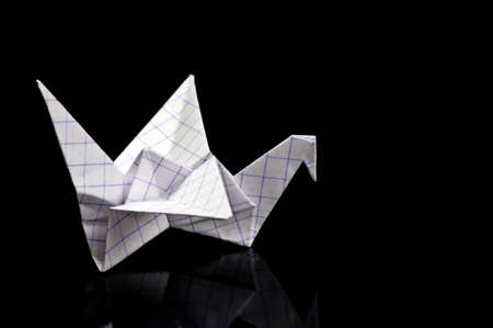 Origami crane on black background の写真素材