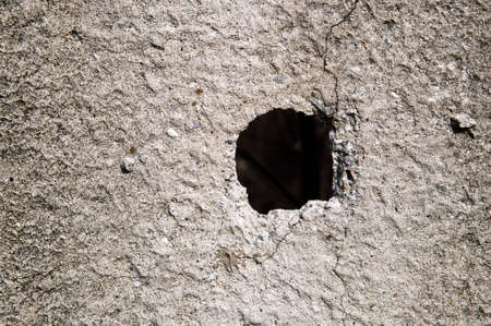 Hole in concrete wall structureの写真素材