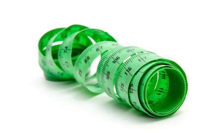 Curled green measuring tape on white background