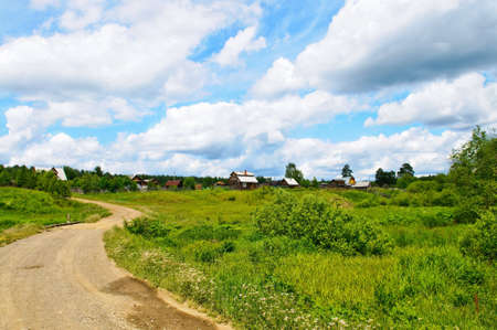 Country road near green farmlandの写真素材